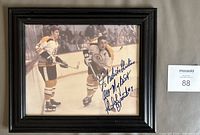 Framed photograph showing Bobby Orr and Phil Esposito with visible signature