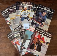 Eleven Scotiabank Hockey News magazines fan-arranged on floor