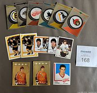 Front view showing all 14 NHL stickers including team logo foils, Ray Bourque duplicates and Steve Yzerman sticker