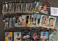 Stacked and spread 1971 black-border cards with MaxSold ID card visible