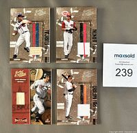 Front view of four Donruss Leather & Lumber relic cards showing embedded bat/jersey pieces