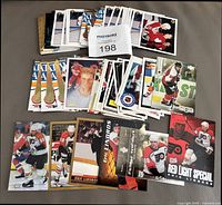 Pile and spread of Eric Lindros hockey cards showing quantity and variety