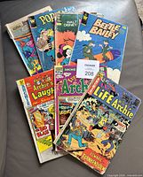 Stack of seven comics fanned out showing titles