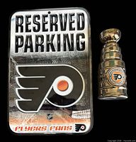 Front view of both items: parking sign and Stanley Cup replica