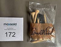 Front view of sealed Arnold Palmer accessory package showing tees, divot tool, markers