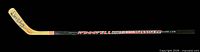 Full view of Winnwell wooden hockey stick showing autograph on blade and shaft graphics
