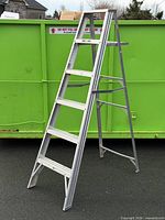 Full view of aluminum 6ft step ladder standing open