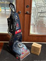 Full view of Bissell carpet cleaner with boxed accessories