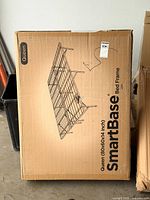 Sealed retail box showing SmartBase queen bed frame graphic