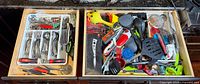 Overview of two open drawers showing all flatware, utensils and tools