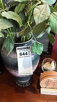 Chinese style vase with artificial foliage and MaxSold tag visible