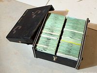 Open black DJ case filled with two rows of sleeved 45 RPM records.