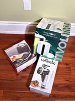 Three boxed kitchen items: Wancle sous vide cooker, Governor's Table waffle maker, Tivoli stock pot