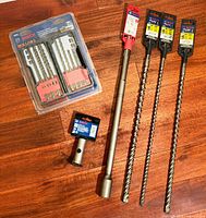 Group shot of all six Bosch drill accessories on wood surface