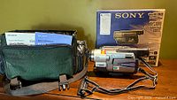 Camcorder, carry bag, manuals, and original box on display