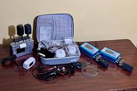 Full lot overview showing Generator X, two blue generators, carry case with accessories, cables