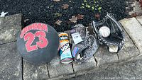 Group shot of basketball, two baseball gloves, baseball and Voit tin