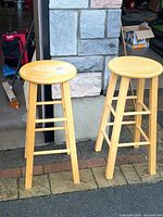 Two matching wooden bar stools at doorway