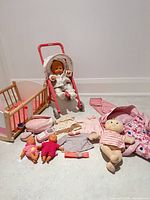 Group shot of stroller, crib, bunting, dolls, clothes and purse accessories