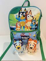 Front of Bluey backpack with plush toys displayed