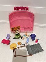 Overview showing carrying case, three dolls, sled, hat, guitar, bench, chair, armchair