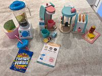 Overview of smoothie maker, coffee maker, stand mixer, toaster and all accessories laid out