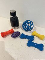 Group shot showing water bottle and all six dog toys