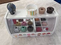 Front view of wooden ice-cream counter with scoops and toppings visible