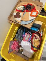overview showing felt pizza, muffin tray, strainer, baskets and assorted pieces in yellow bin