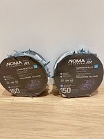 Front view of two sealed NOMA Advanced Constant-Lit 150-bulb LED cluster light sets