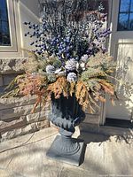 Full view of one urn planter with winter arrangement