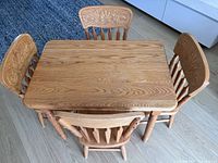 Top view of solid oak children’s table with four matching chairs