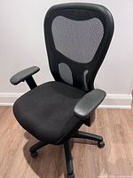 Front angled view of black Tempur-Pedic office chair showing mesh back, memory-foam seat, armrests and caster base