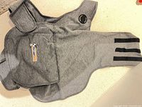 ThunderShirt wrap laid flat showing overall shape, closures and pocket