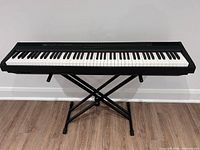 Front view of Yamaha P-105 keyboard on X-style stand