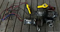 Two electric winches with cables, hooks, remotes, wiring