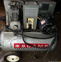 Front view showing pump, motor, tank, wheels and branded Scamp decal