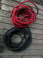 Coiled red and black air hoses on deck