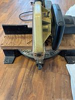 Top view of Black & Decker miter saw showing motor housing, fence, rotating base and scale