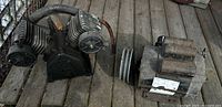 Compressor pump head and electric motor side by side on wooden surface