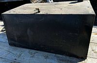 Front/top view of the rectangular steel tank showing overall shape and vent elbow