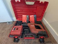 Hilti reciprocating saw, battery, charger, three manuals inside open Hilti case