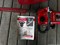 Chainsaw with bar cover and instruction manual