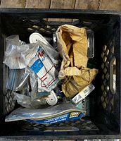 Top view of crate with bags of hardware and brackets