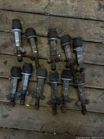 twelve vintage expansion plugs laid out on wood floor