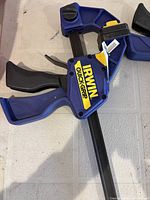 Close-up of blue Irwin Quick-Grip bar clamp