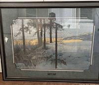 Framed Robert Bateman print behind glass