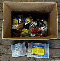 Overview of box contents with two plastic organizers and assorted parts