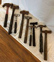 All eight hammers lined on white cloth
