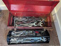 Interior of toolbox with tray and numerous wrenches